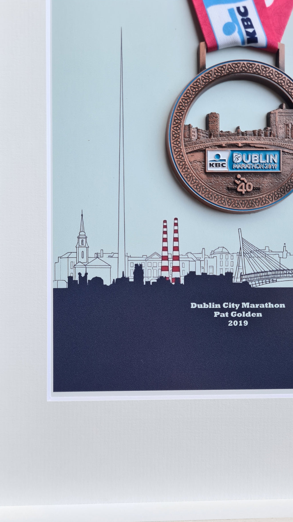 Framed Dublin Marathon Medal over skyline of Dublin City