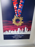 Framed Marathon Medal Over City Skyline