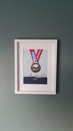 Framed Dublin Marathon Medal over skyline of Dublin City