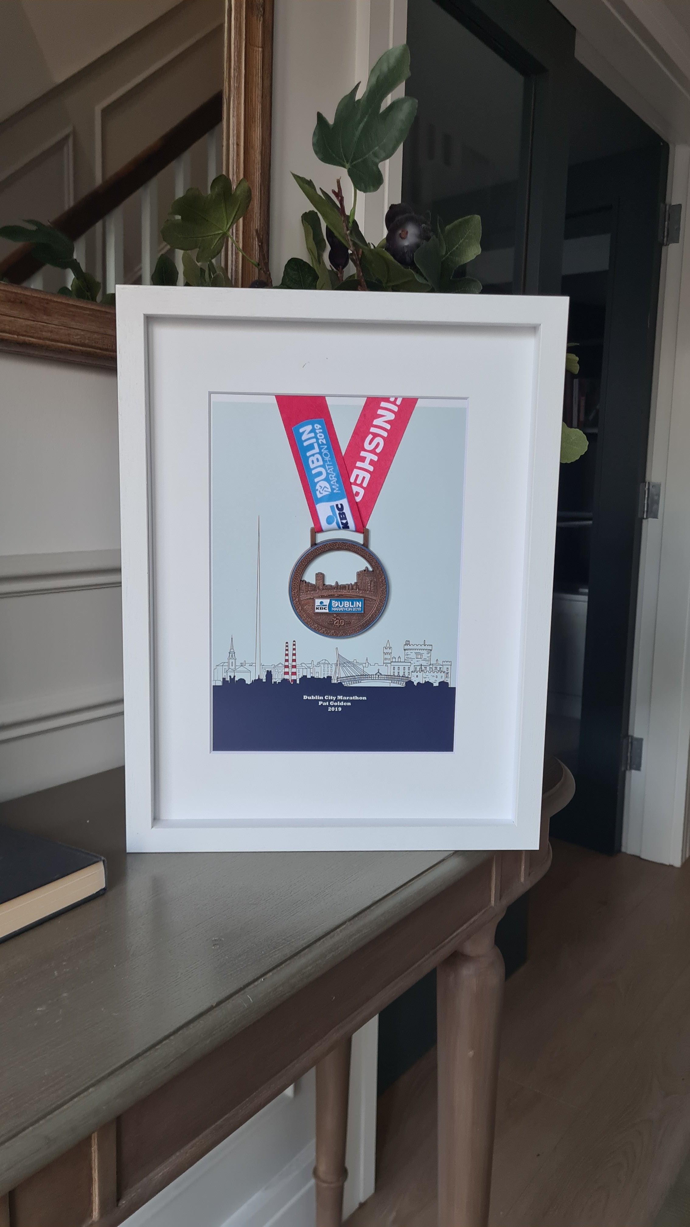 Framed Dublin Marathon Medal over skyline of Dublin City