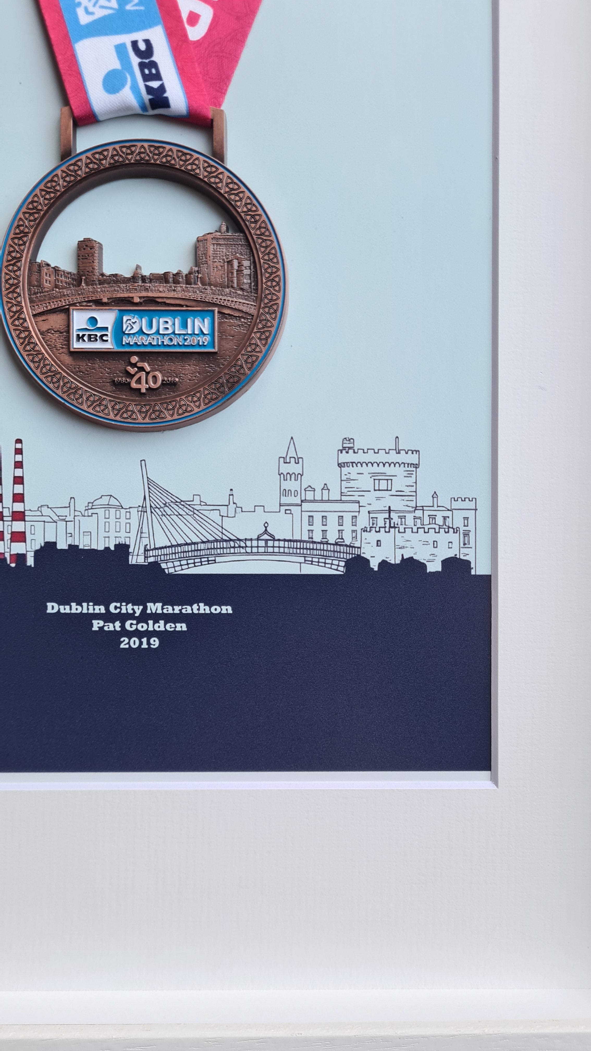 Framed Dublin Marathon Medal over skyline of Dublin City