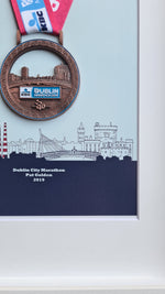 Framed Dublin Marathon Medal over skyline of Dublin City